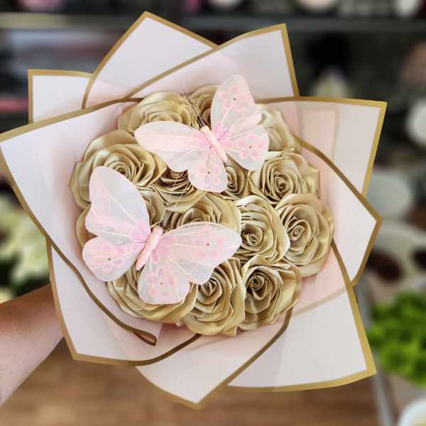 Bouquet of gold satin roses with pink butterfly decorations