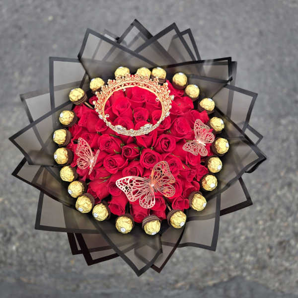 Bouquet of red roses with gold chocolates and butterfly decorations