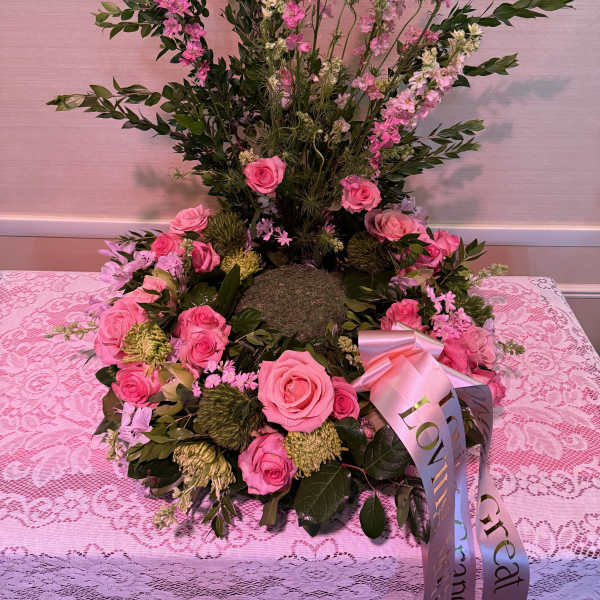 Pink rose wreath with tall pink blossoms and a satin ribbon bow