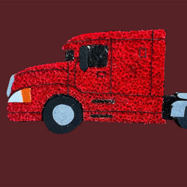 Red toy semi-truck on a solid maroon background