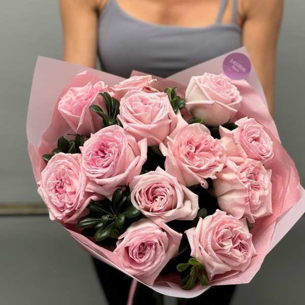Bouquet of pale pink roses wrapped in pink paper