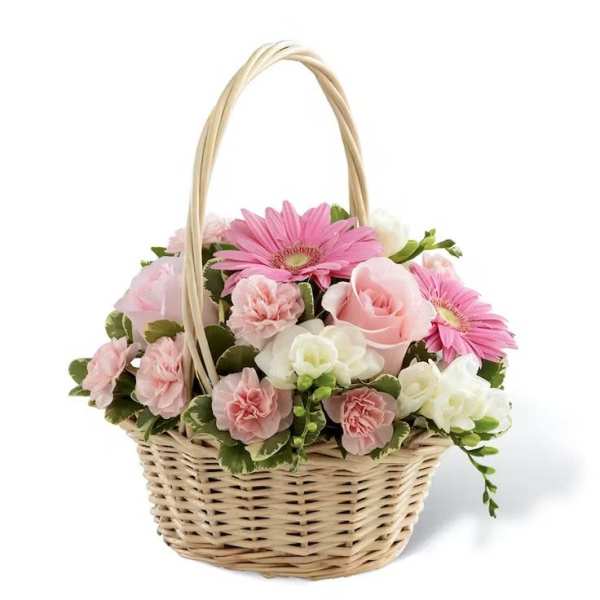 Pink and white flowers arranged in a wicker basket