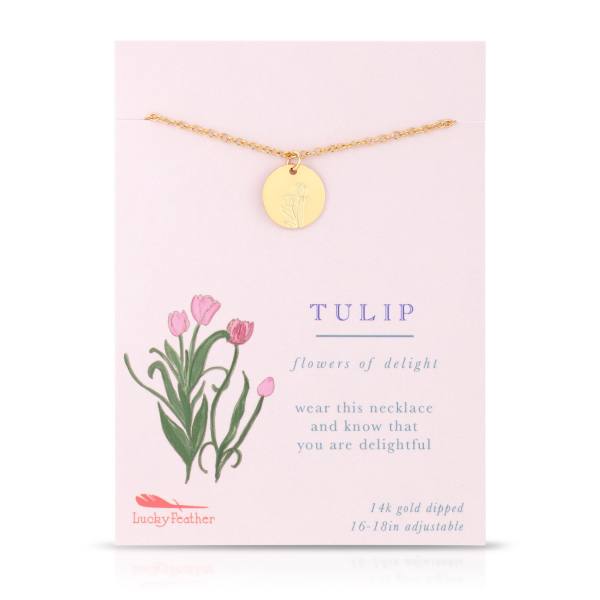 Gold disc necklace with tulip engraving on a pale pink card printed with pink tulips and text