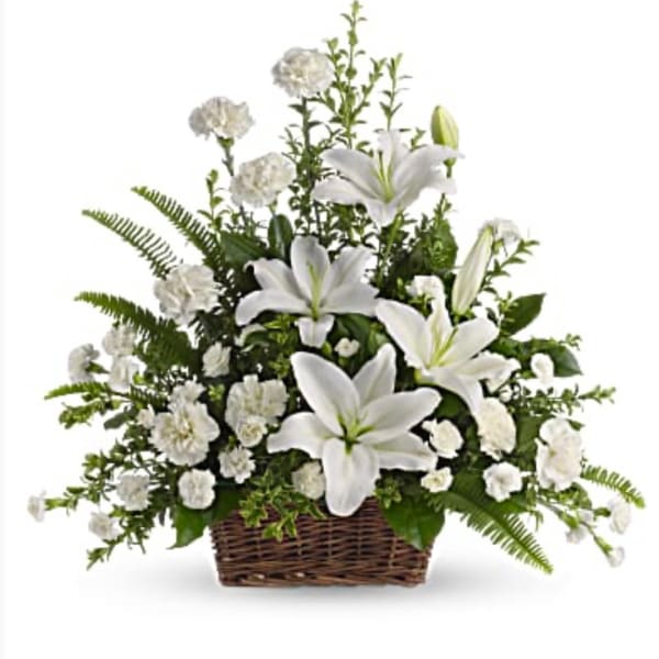 White lilies and carnations in a wicker basket
