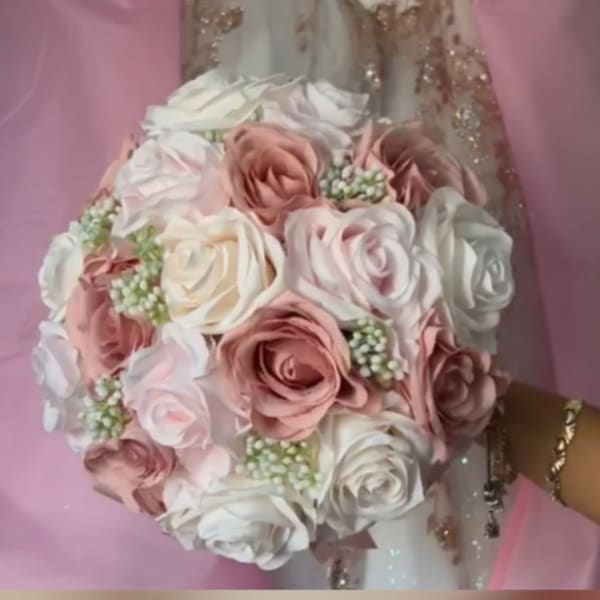 Round bouquet of blush and white roses with small filler flowers