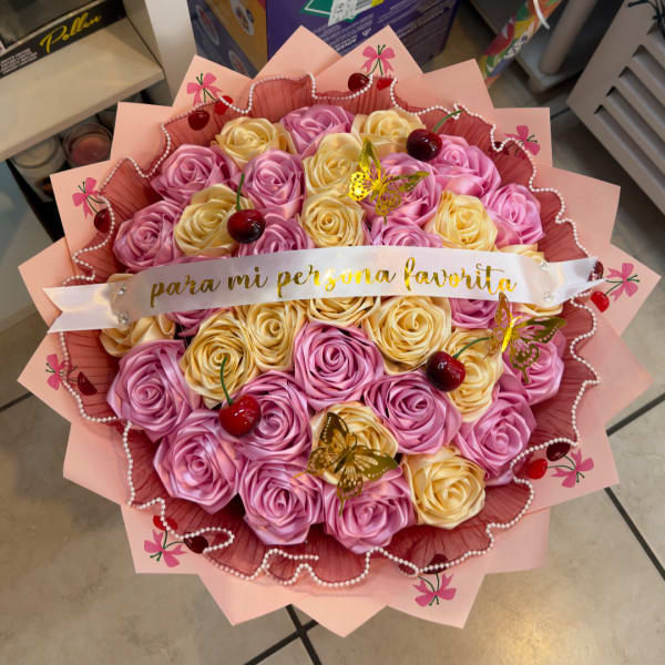 Pink and cream rose bouquet with a ribbon banner