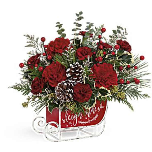 Red floral sleigh arrangement with pinecones and berries