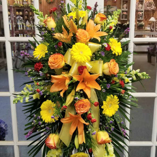 Large standing spray with orange lilies, yellow daisies, and roses