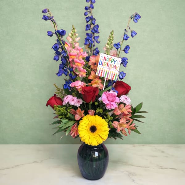 Mixed bouquet in a dark vase with a Happy Birthday card