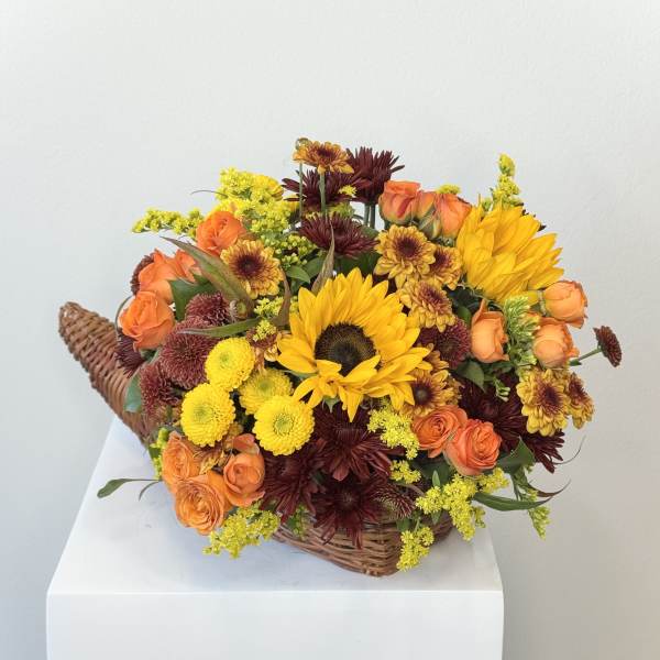 Basket arrangement with sunflowers, orange roses, and chrysanthemums