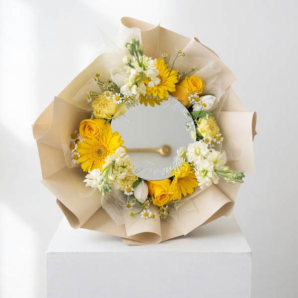 Yellow and white flower bouquet wrapped around a round mirror