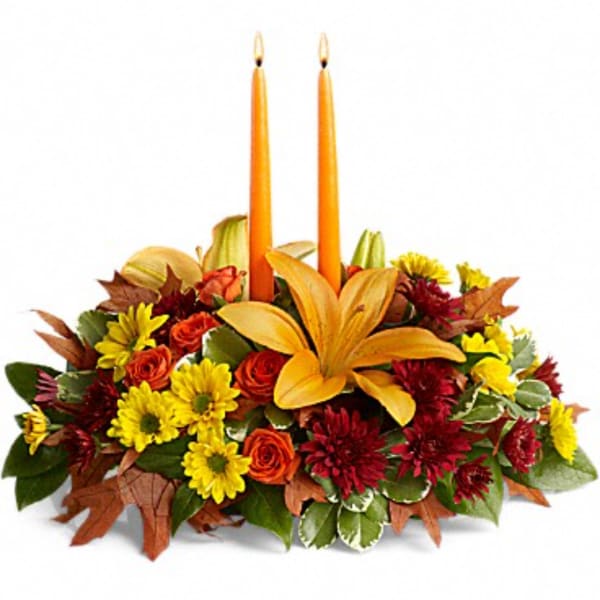 Autumn floral centerpiece with two orange candles