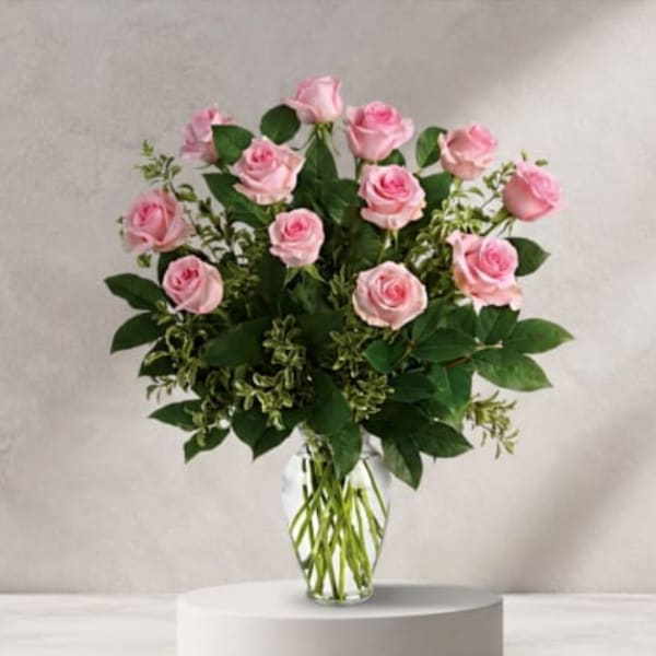 Pink roses arranged in a clear glass vase