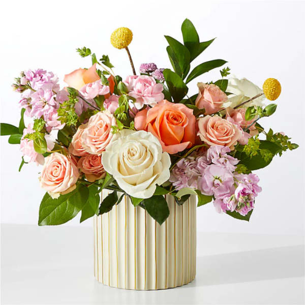 Mixed pink, peach, and white roses in a striped vase
