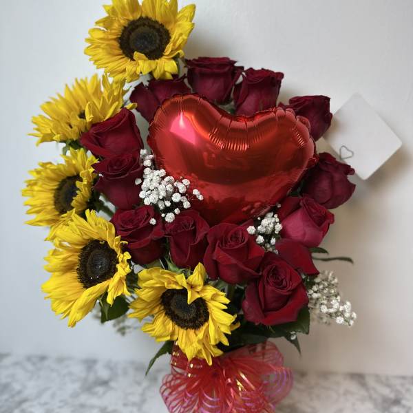 Bouquet of red roses and yellow sunflowers with a red heart balloon
