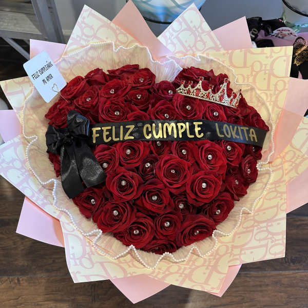 Heart-shaped bouquet of red roses with a crown and black ribbon