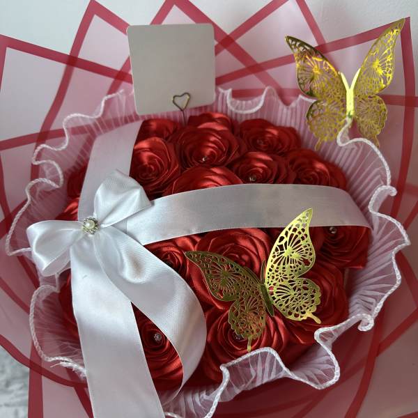 Red satin rose bouquet with white ribbon and gold butterfly accents