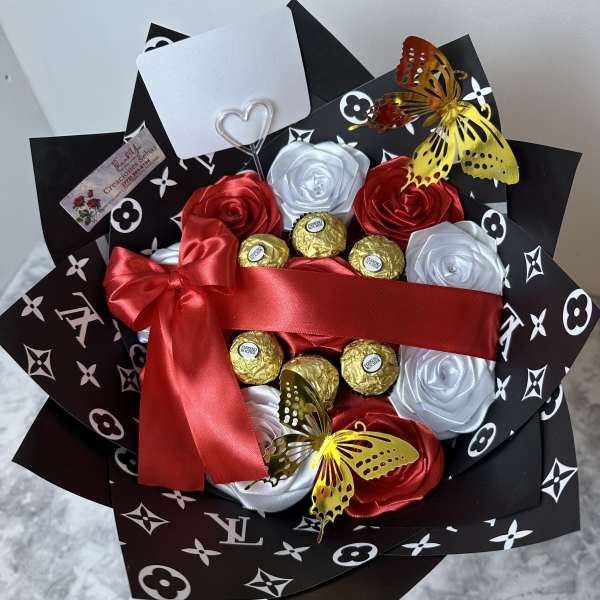 Bouquet of satin roses with chocolates and butterfly accents