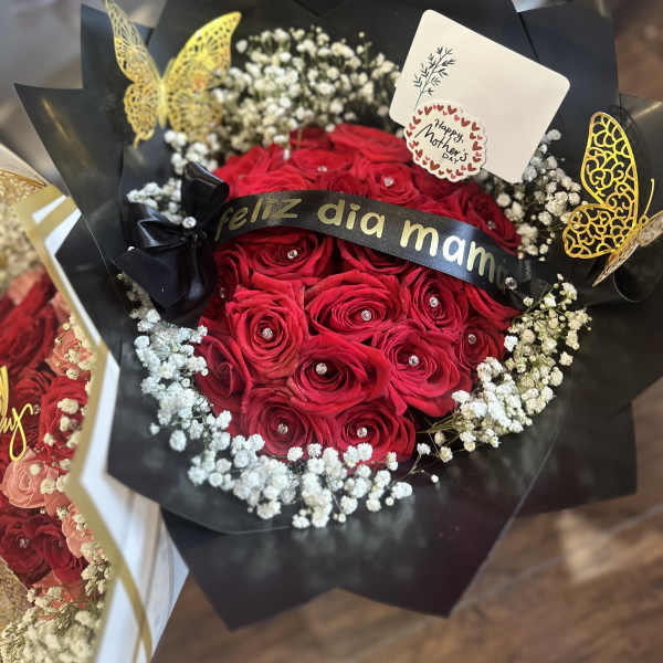 Red rose bouquet with baby's breath and a Mother's Day card
