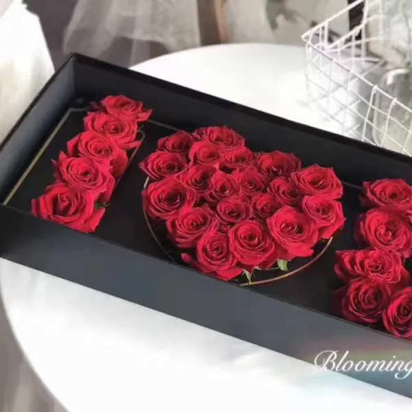 Red roses arranged in a black gift box to form the number 520