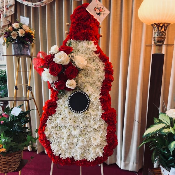 Large red and white floral standing display on an easel