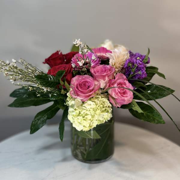 Mixed bouquet of pink and red roses in a glass vase