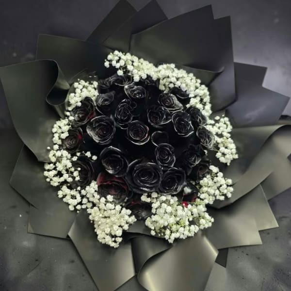 Black rose bouquet with white baby's breath in dark wrapping