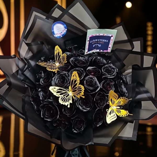 Black rose bouquet with gold butterfly decorations and black wrapping