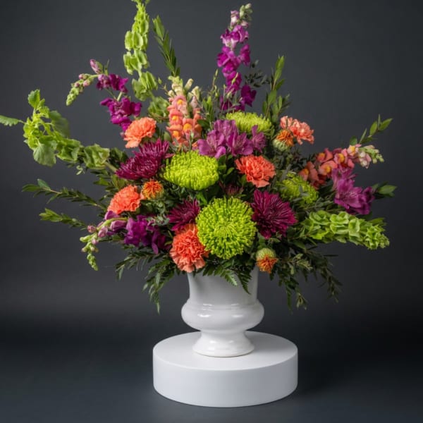 Colorful mixed flower arrangement in a white vase