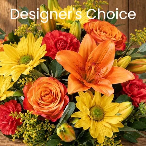 Bright mixed bouquet with orange roses, yellow daisies, red carnations, and an orange lily