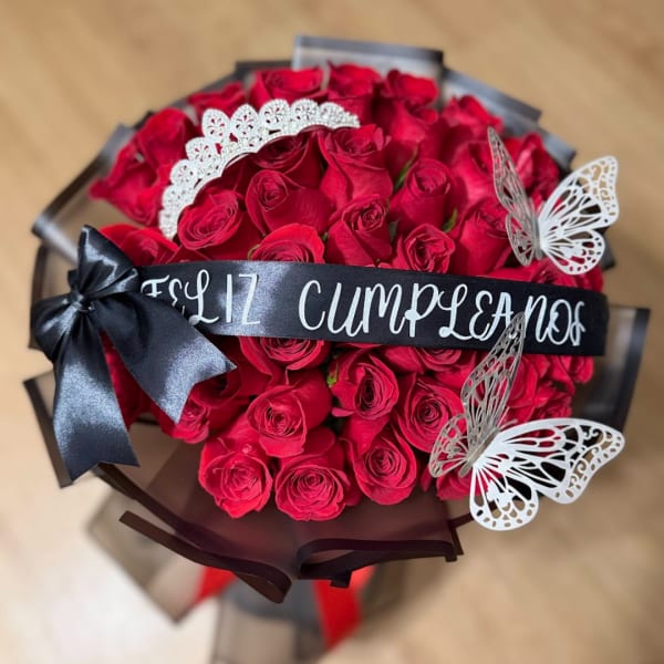 Bouquet of red roses with a black ribbon and butterfly decorations
