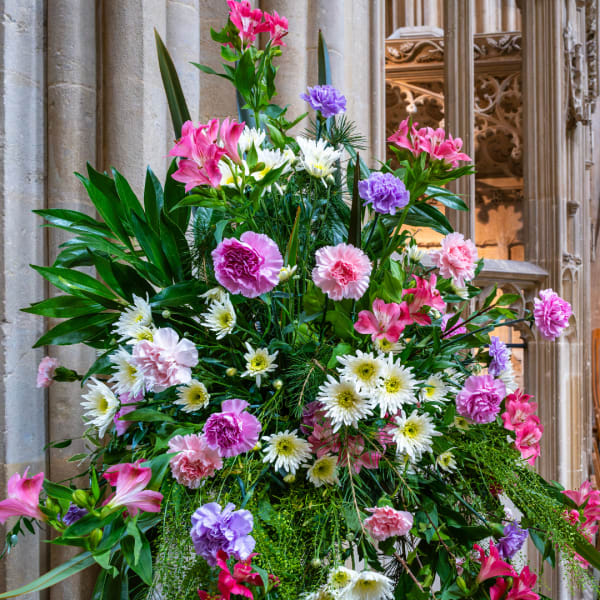 Large floral arrangement with pink, purple, and white blooms
