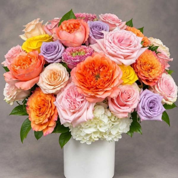 Mixed roses and hydrangea in a white vase
