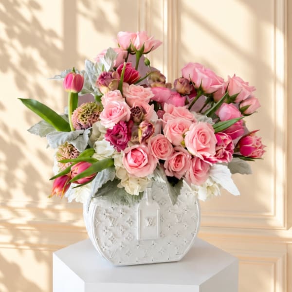 Pink rose bouquet in a white decorative vase