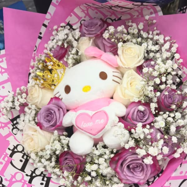 Bouquet of purple and white roses with a Hello Kitty plush in pink wrapping