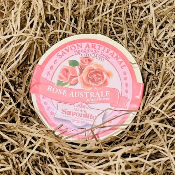 Round pink soap bar in straw filler with rose label