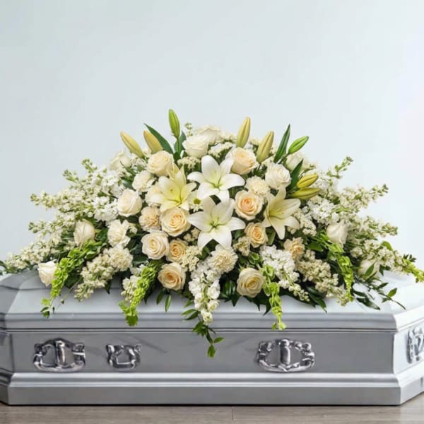 White floral spray on a silver casket