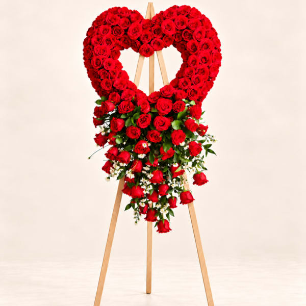 Heart-shaped red rose standing arrangement on a wooden easel