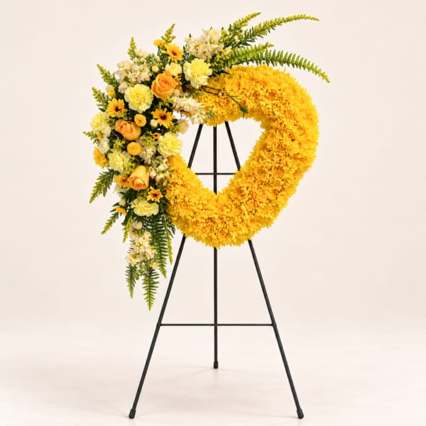 Yellow floral wreath on a black standing easel