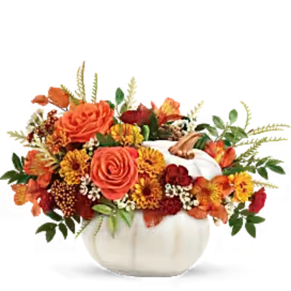 Orange and yellow floral arrangement in a white pumpkin vase