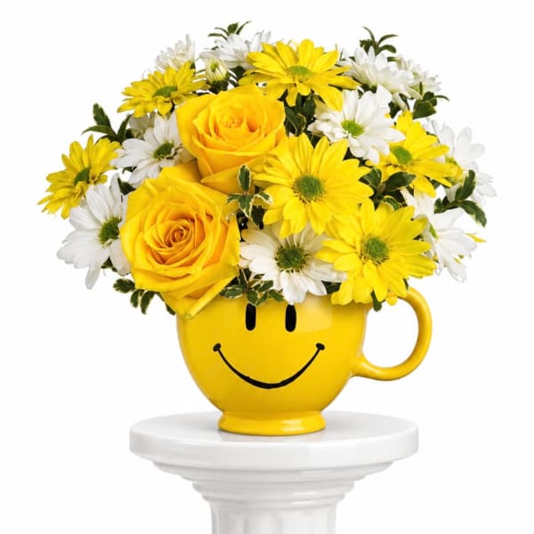 Yellow roses and white daisies in a smiley-face mug