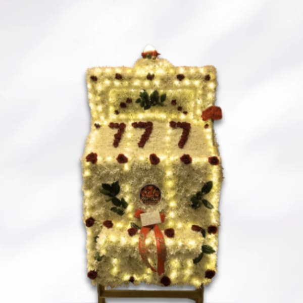 Floral display shaped like a slot machine with 777 on the front
