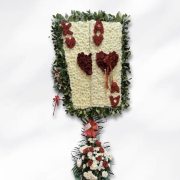 Floral standing tribute with red and white flowers on a green frame
