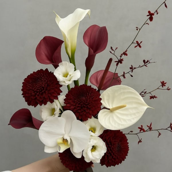Bouquet with white orchids, burgundy calla lilies, and dark red mums