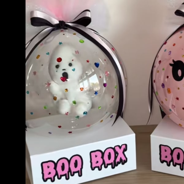 Clear balloon gift box with a white teddy bear and black ribbon bow
