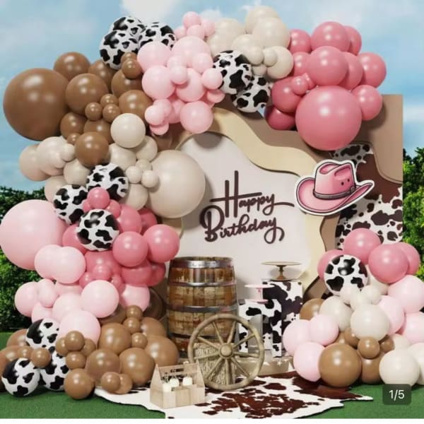 Balloon birthday backdrop with pink, brown, white, and cow-print balloons