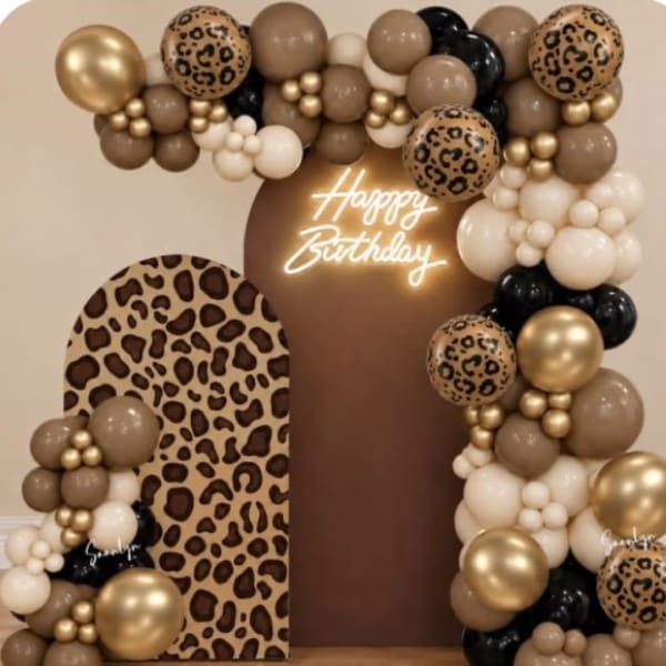 Leopard-print and gold balloon birthday display with a large "Happy Birthday" sign