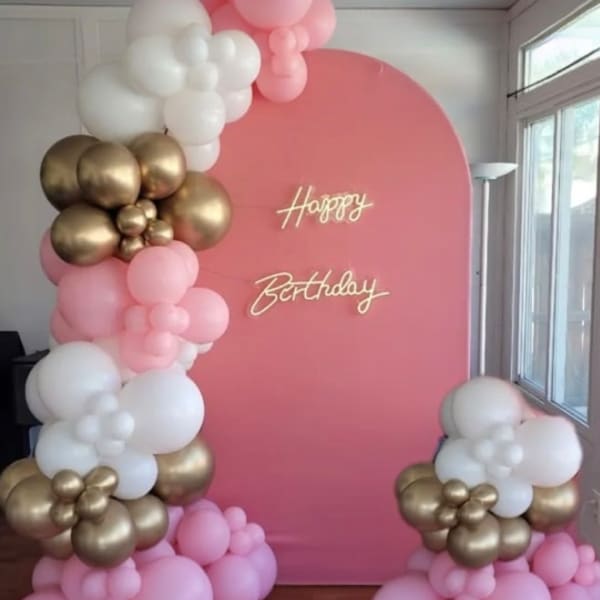 Pink birthday backdrop with white, pink, and gold balloon clusters