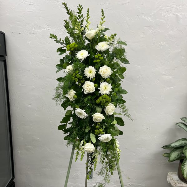 Tall white floral standing spray with roses and mums on a tripod easel