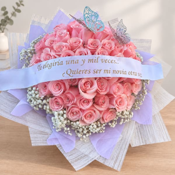 Pink rose bouquet with a ribbon banner and butterfly decorations